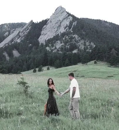 WOMAN WALKING TO THE MOUNTAIN holding hannd man